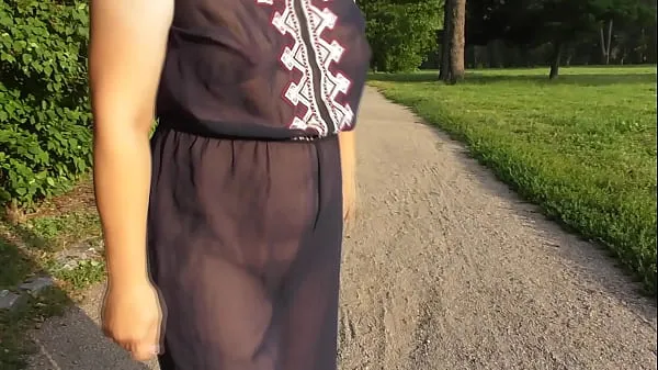 Klip berkendara Chubby woman in transparent dress in public park HD